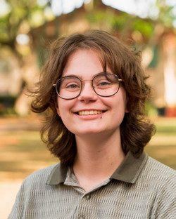 individual with brown hair wearing olive green polo shirt