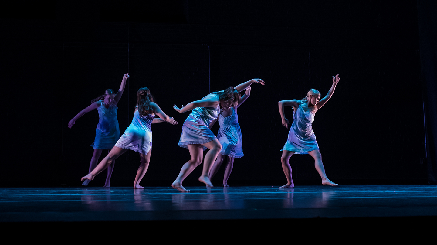 Five dance students performing on stage