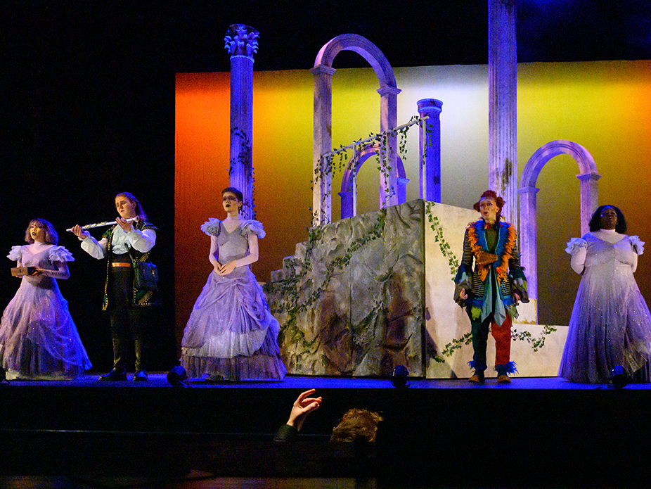 Opera students in costume singing on stage