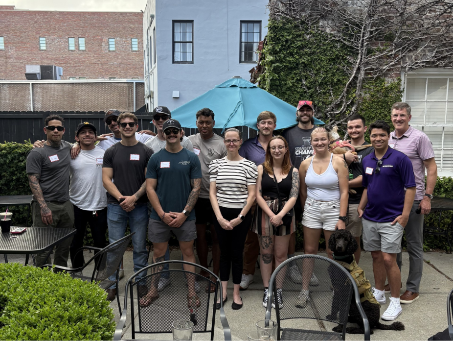 A group of people smiling outside.