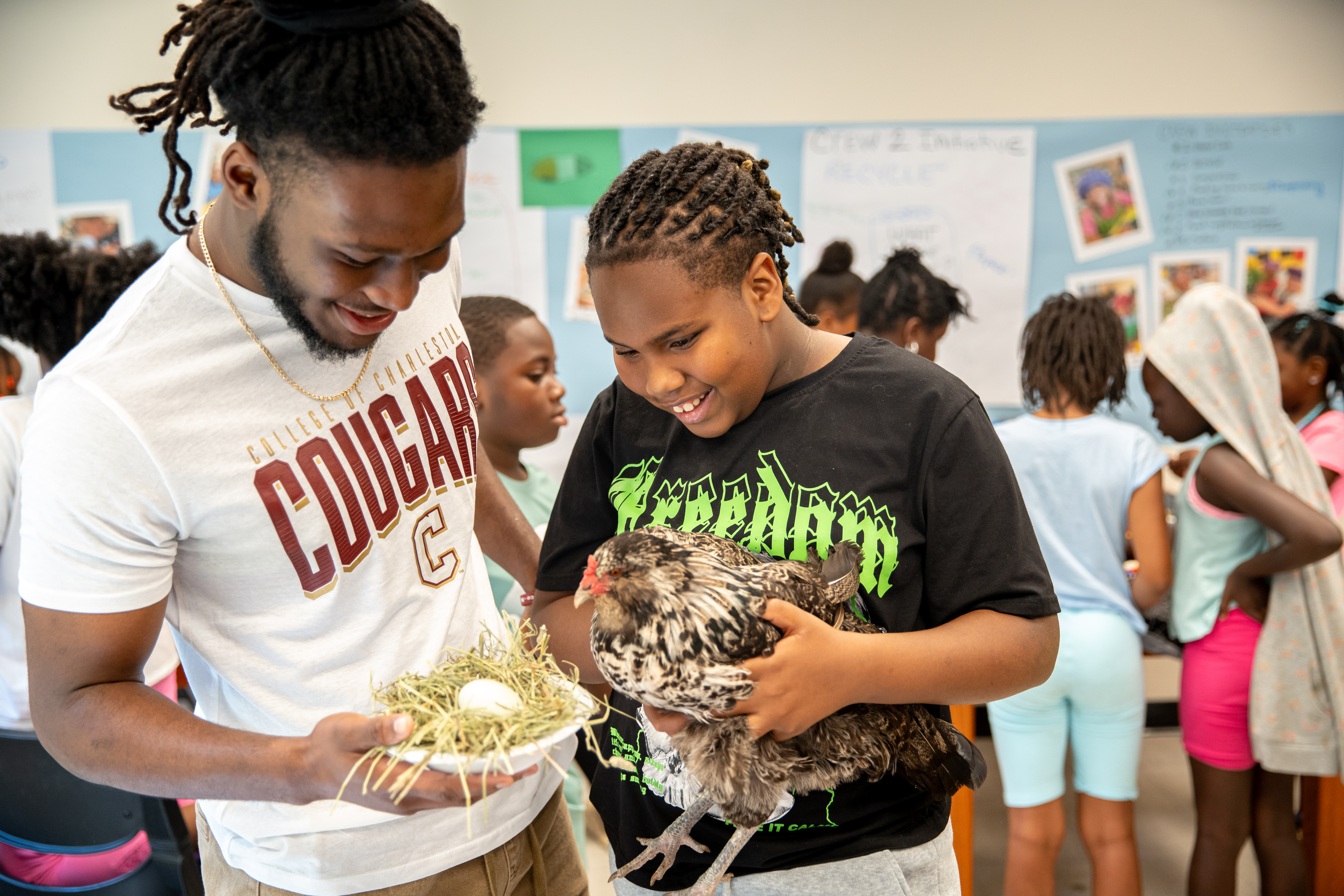 student learning holding chicken