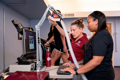 Exercise Science student Bency Young works with Lab Manager, Liza Reader on VO2 Max Testing