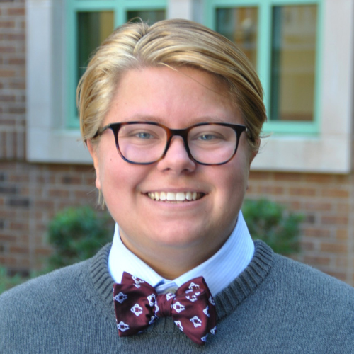 Headshot of Cheyenne Litte with short blonde hair, wearing a bow-tie.