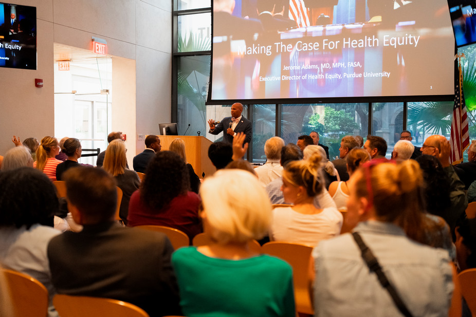 speaker leads presentation in front of a big crowd