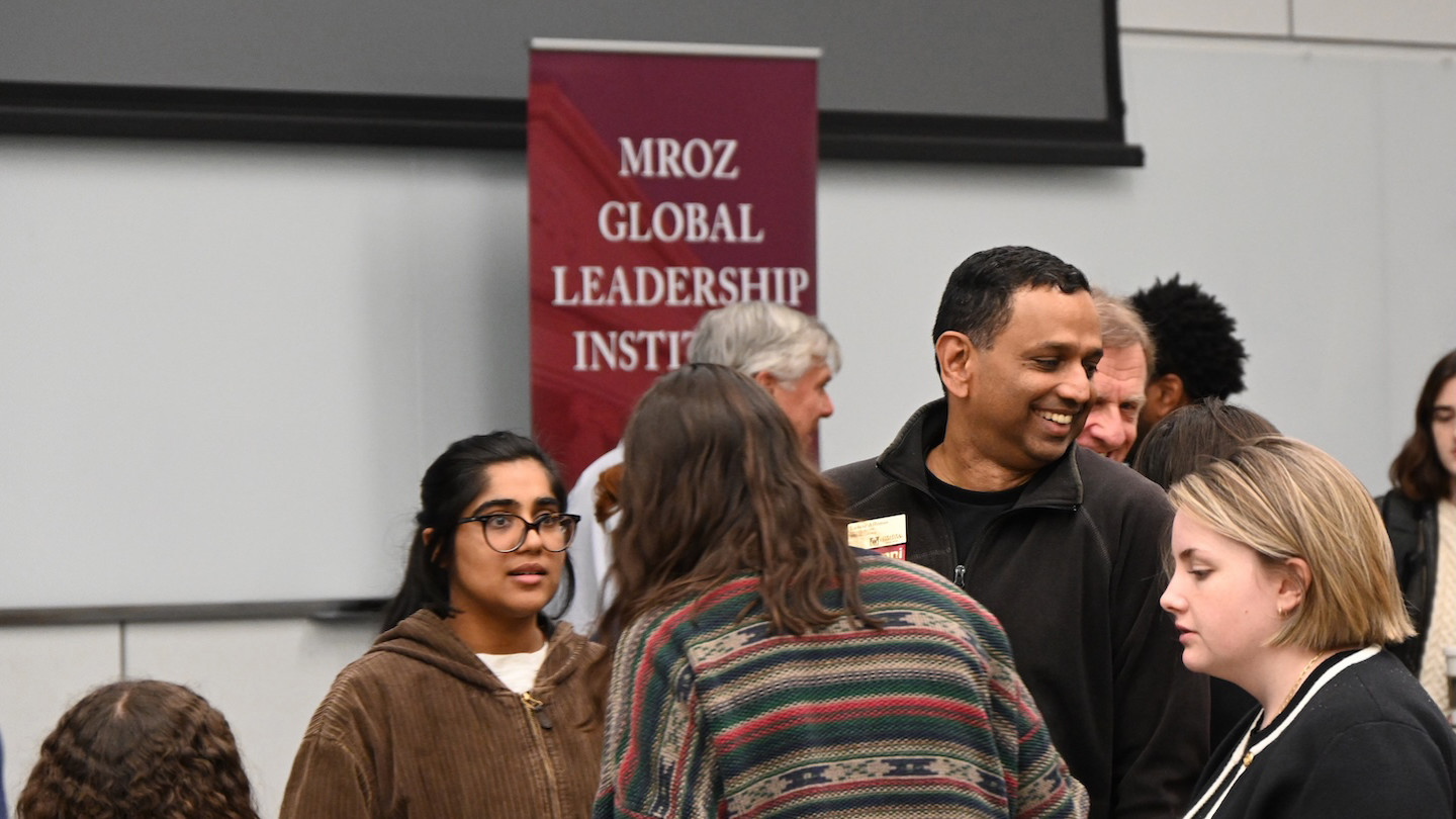 Group of individuals talking during the Mroz Global Leadership Summit event.