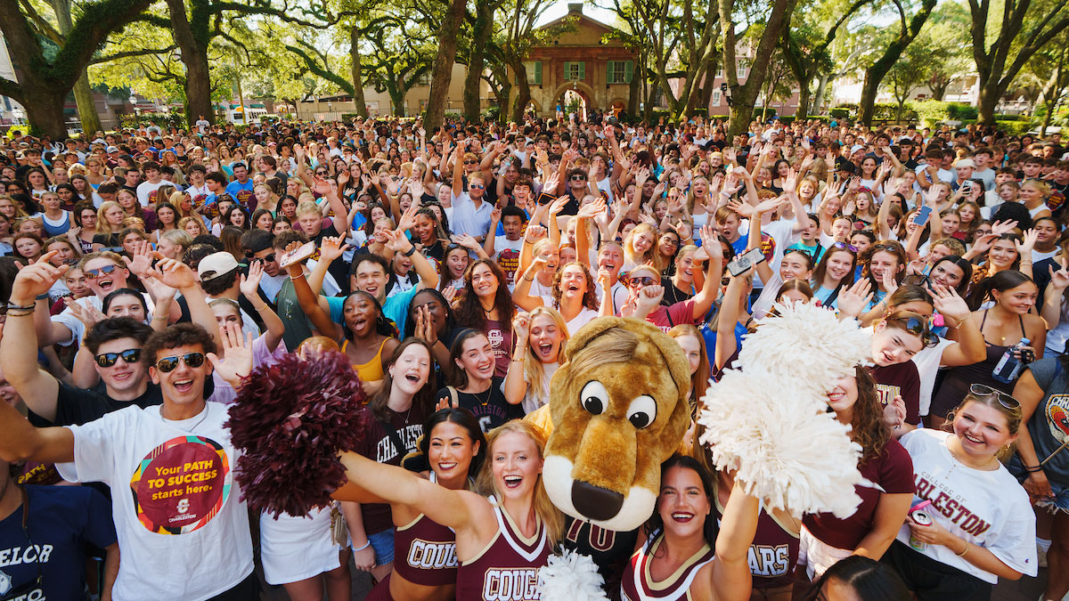 A crowd of College of Charleston students celebrating with Clyde, the mascot. 