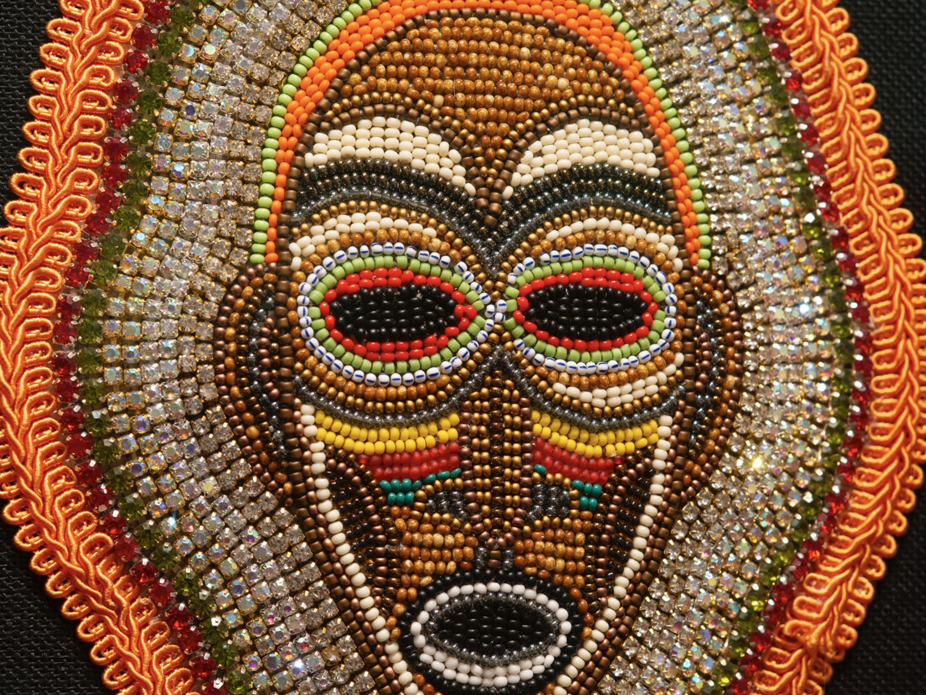 A glass bead and canvas piece of Black Masking culture by artist Demond Melancon 