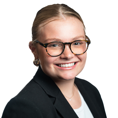 Professional headshot of Allyn Roedel, a young woman with glasses and a smiling expression, wearing a black blazer.