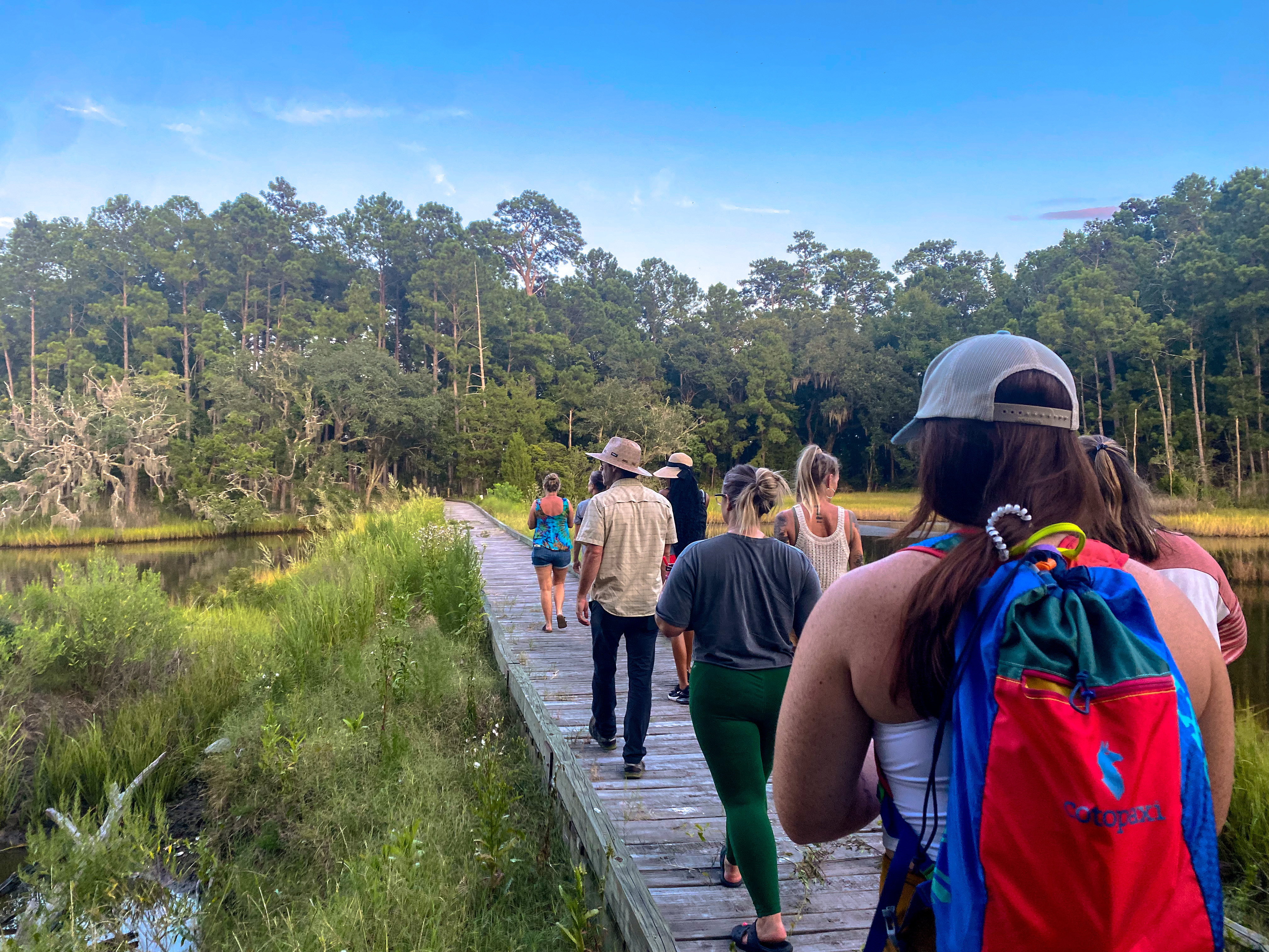 a group of students on a boardwalk at Stono Preserve, going on a nature walk