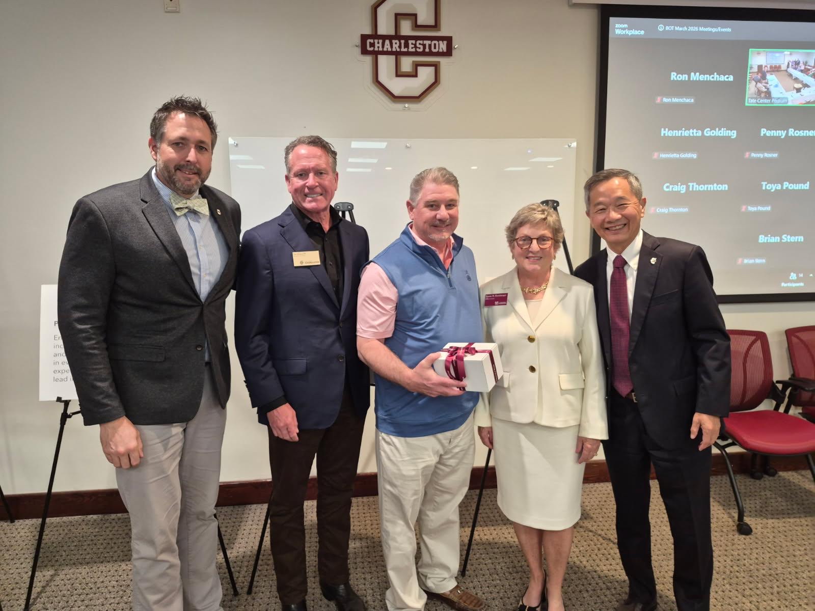 Three Board of Trustee Members and President Hsu present honor a trustee for their service to the College. 