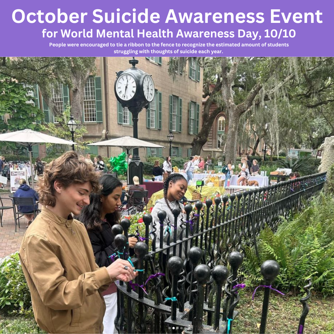 An image of students adding purple and teal ribbons to a fence